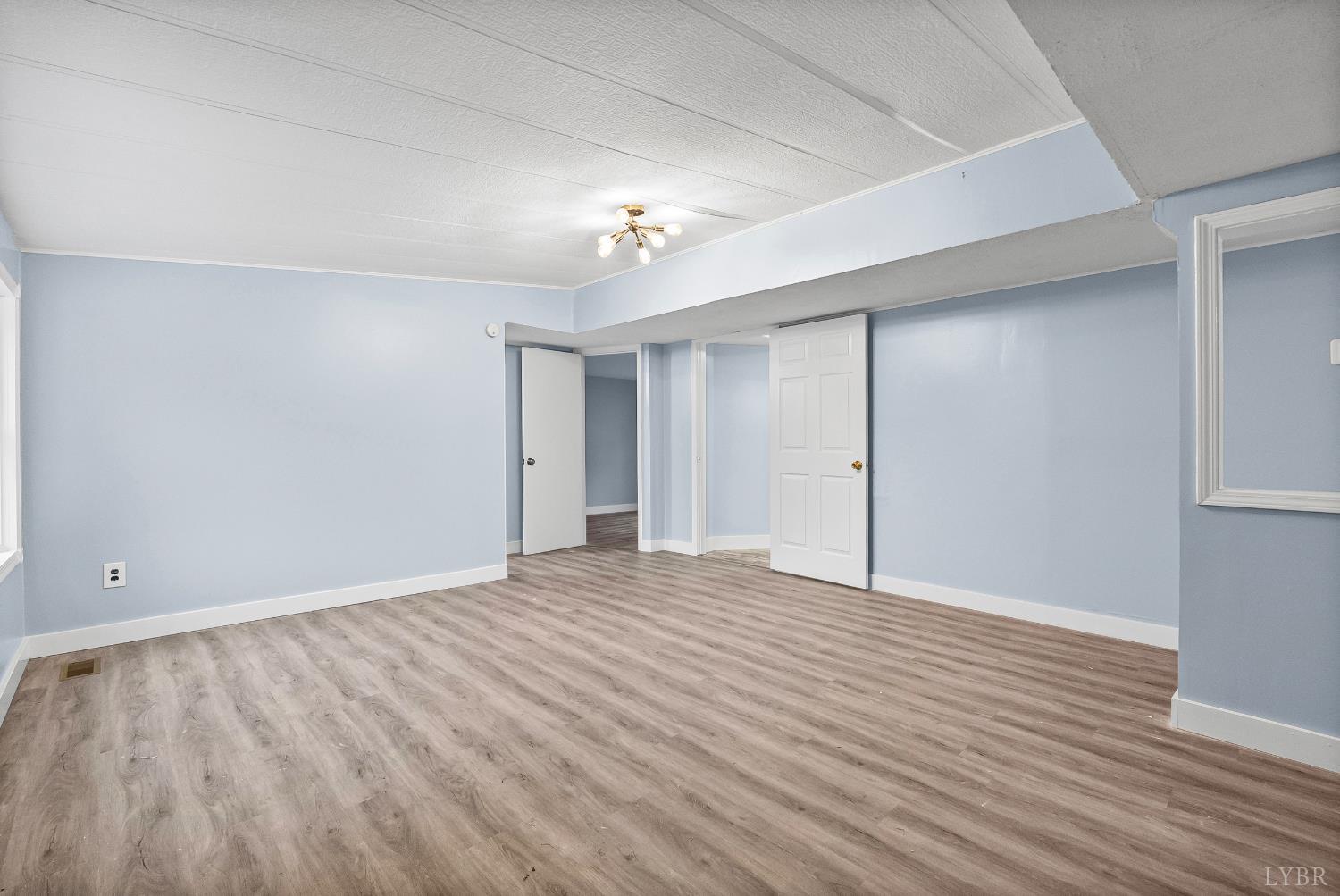 2443 Sunnymeade Road Rustburg, VA 24588 - Photo 4 of 36 wooden floor in an empty room with a window