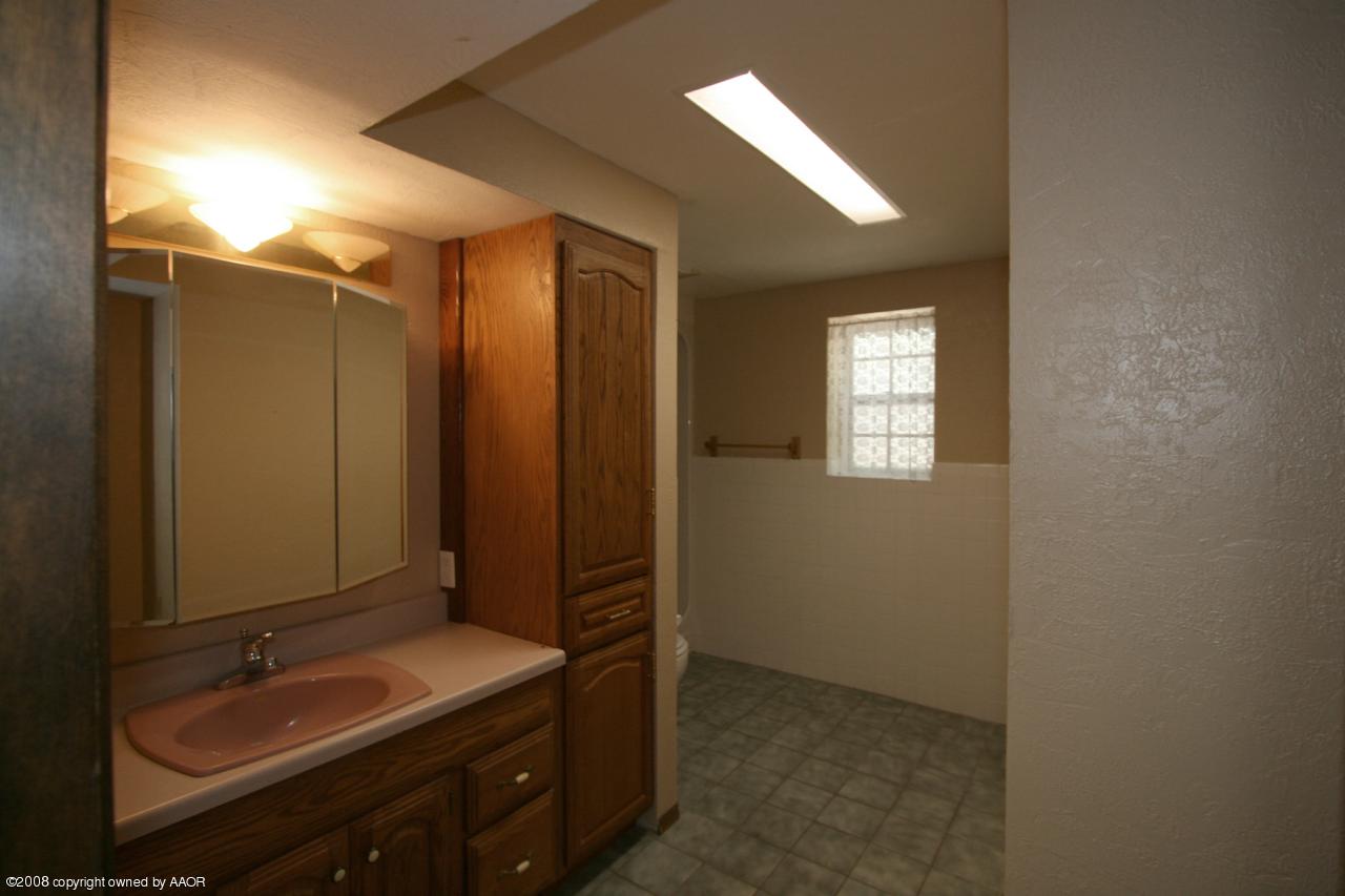 4250 Arden Road Amarillo, TX 79110 - Photo 5 of 22 a bathroom with a double vanity sink and mirror