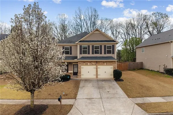 a front view of a house with a yard