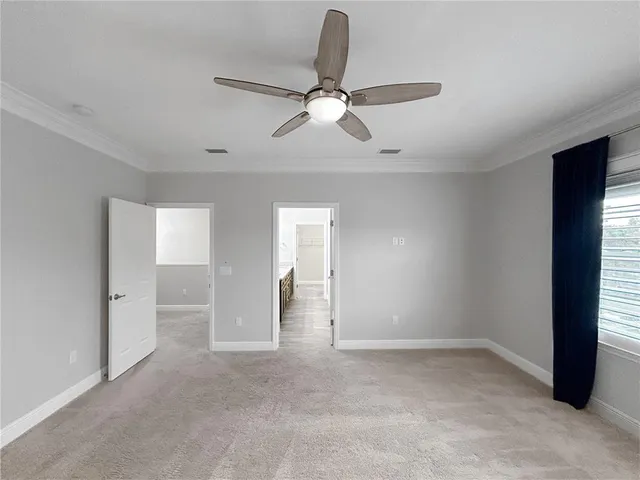 a view of empty room with ceiling fan
