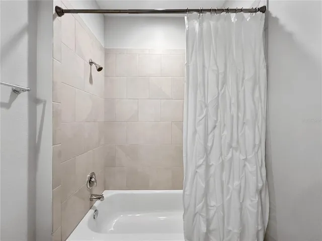 a bathroom with a shower and a bath tub