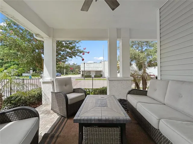 a living room with furniture fireplace and a large window