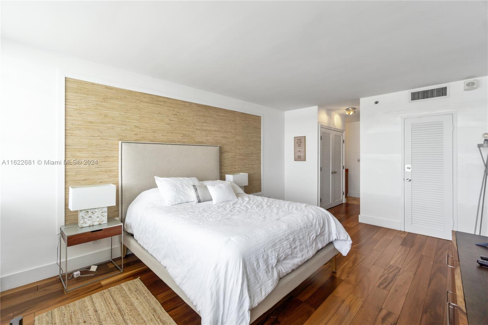 100 Lincoln Road, Unit 1422 Miami Beach, FL 33139 - Photo 11 of 35 a bedroom with a bed and wooden floor