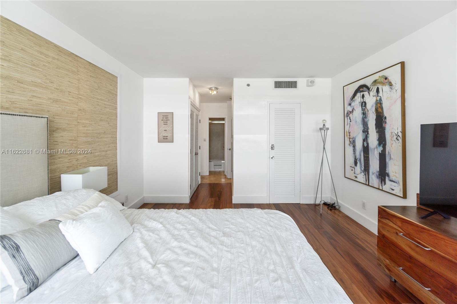 100 Lincoln Road, Unit 1422 Miami Beach, FL 33139 - Photo 14 of 35 a bedroom with a bed and a flat screen tv