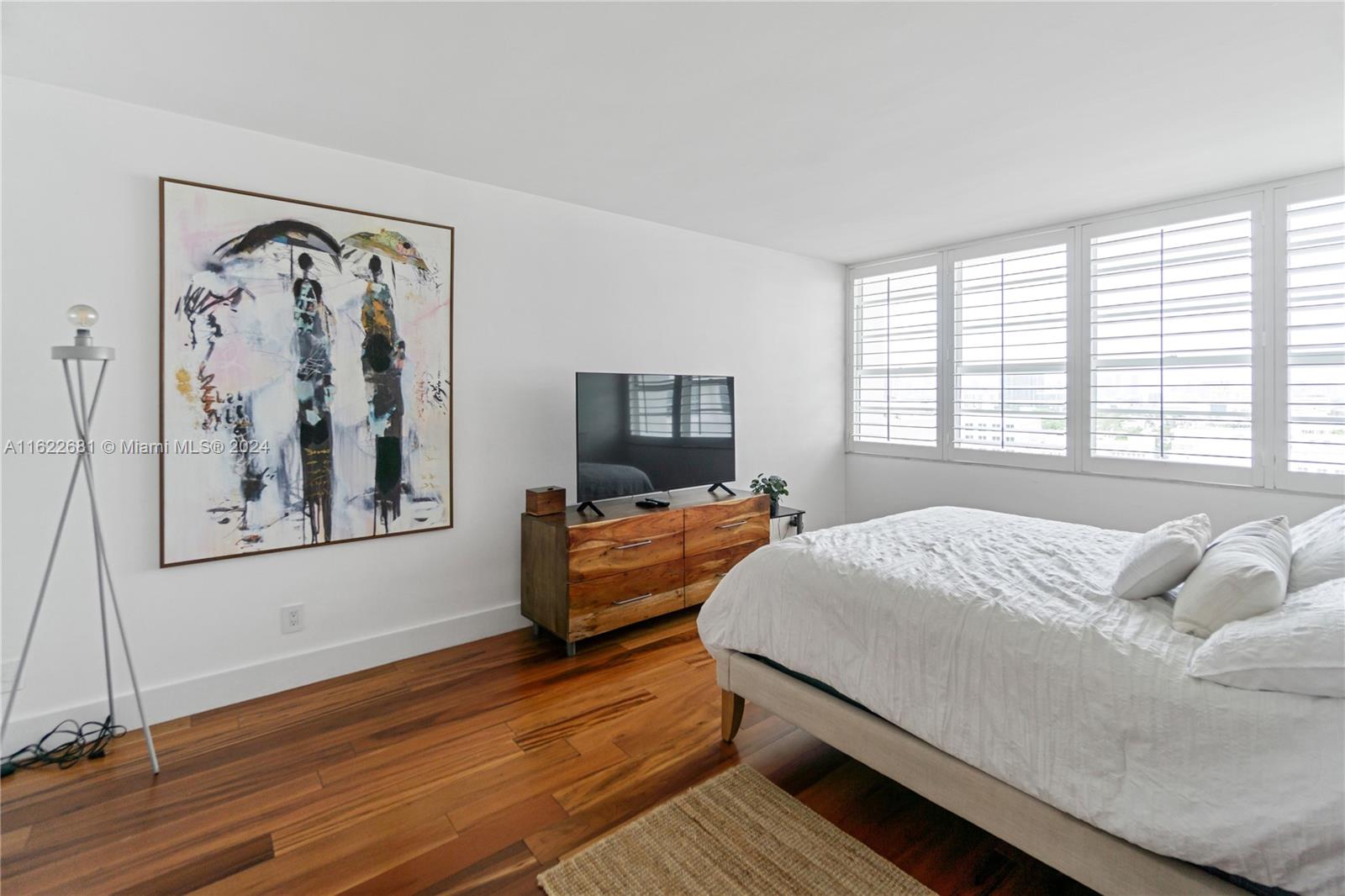 100 Lincoln Road, Unit 1422 Miami Beach, FL 33139 - Photo 15 of 35 a bedroom with a large bed and a window