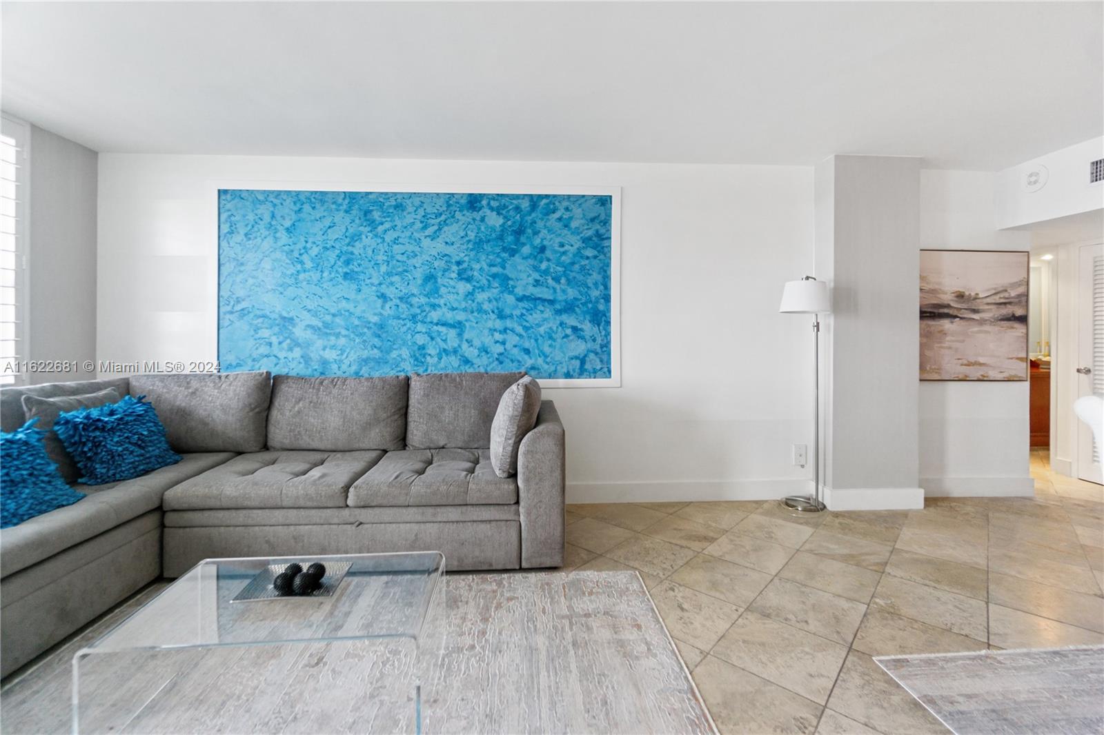 100 Lincoln Road, Unit 1422 Miami Beach, FL 33139 - Photo 4 of 35 a living room with a couch and a large window