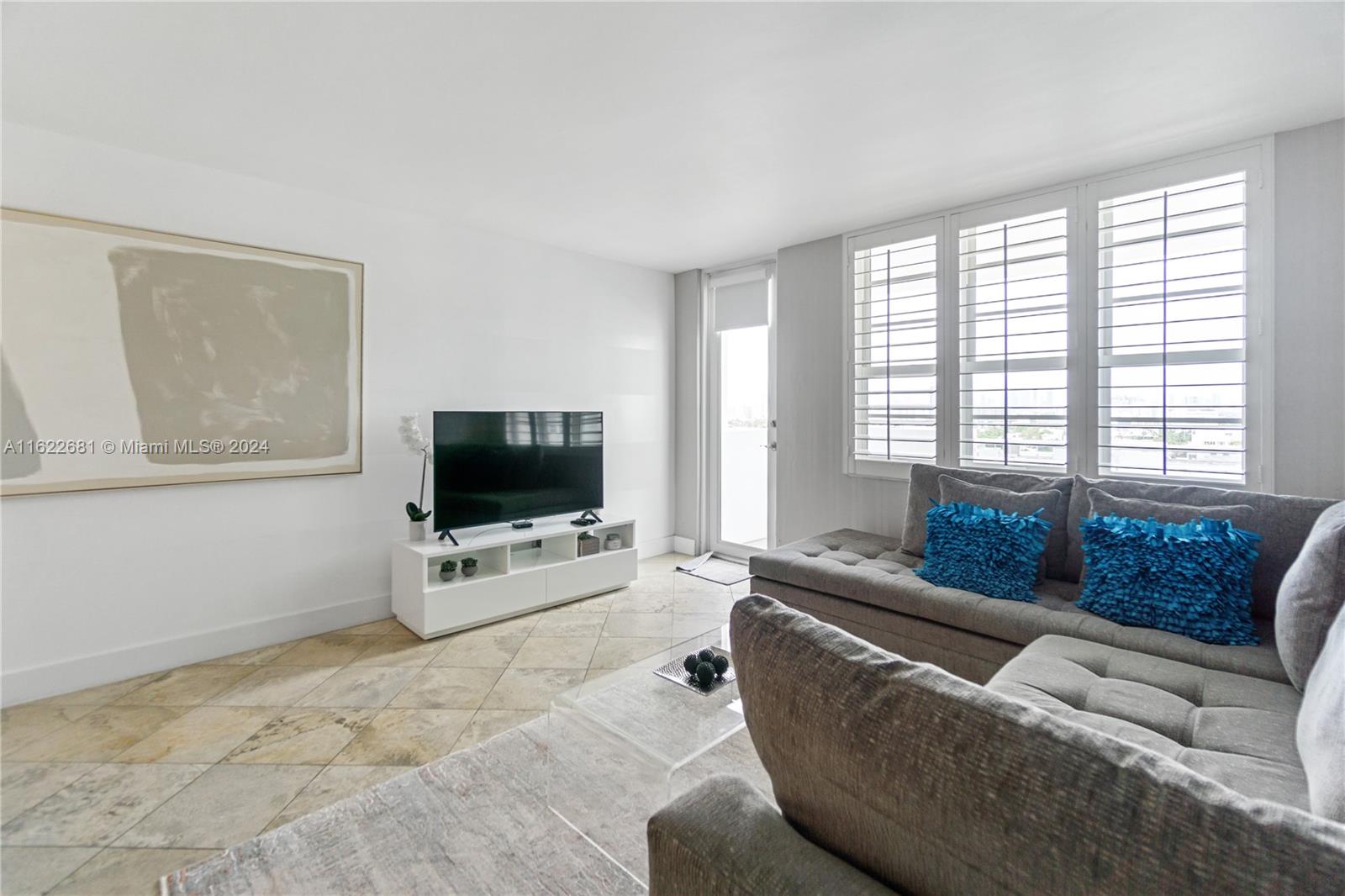 100 Lincoln Road, Unit 1422 Miami Beach, FL 33139 - Photo 6 of 35 a living room with furniture and a flat screen tv