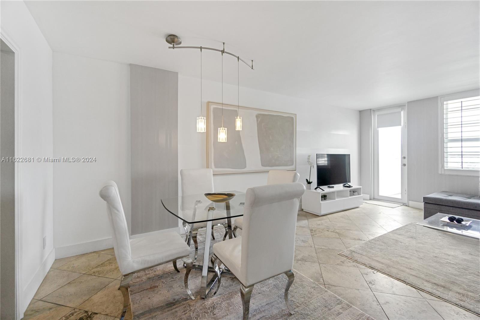 100 Lincoln Road, Unit 1422 Miami Beach, FL 33139 - Photo 8 of 35 a living room with furniture a flat screen tv and kitchen view