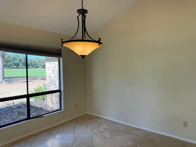 a view of a room with a window and chandelier