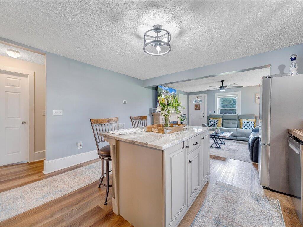 214 Spring Road Patrick Springs, VA 24133 - Photo 11 of 49 a view of dining table chairs and refrigerator