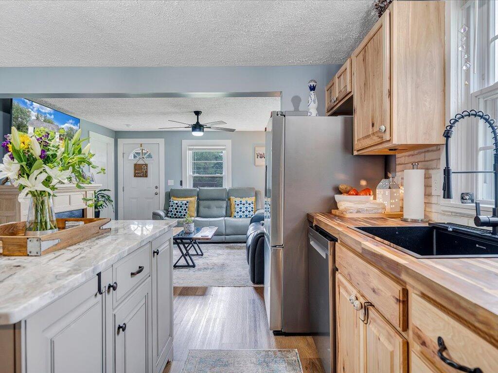 214 Spring Road Patrick Springs, VA 24133 - Photo 12 of 49 a kitchen with stainless steel appliances granite countertop a sink stove and refrigerator