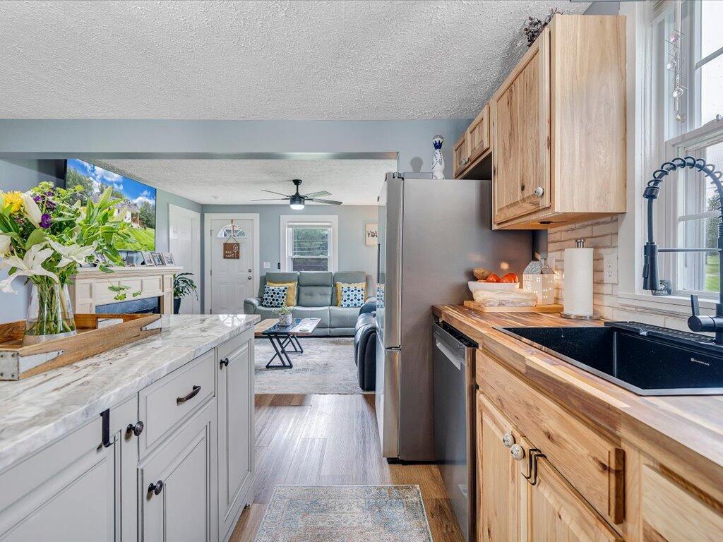 214 Spring Road Patrick Springs, VA 24133 - Photo 13 of 49 a kitchen with granite countertop a sink stove and cabinets