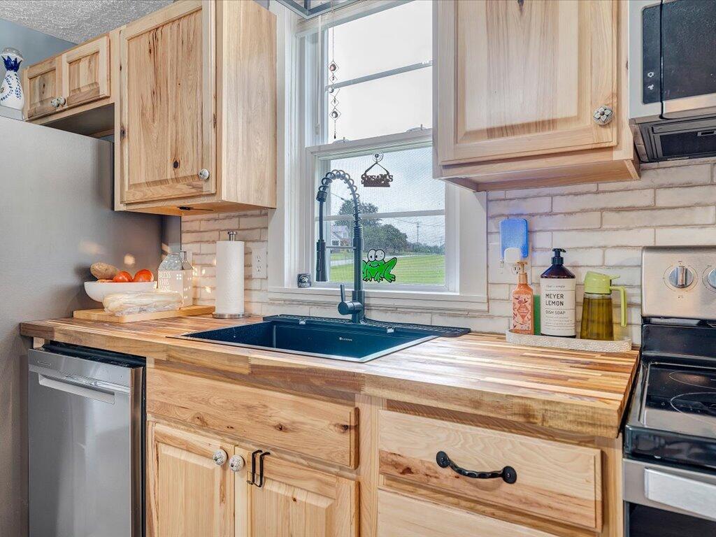214 Spring Road Patrick Springs, VA 24133 - Photo 15 of 49 a kitchen with stainless steel appliances granite countertop a sink and a cabinets