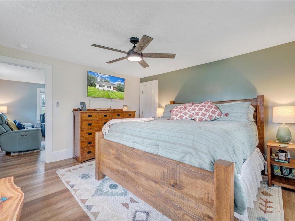 214 Spring Road Patrick Springs, VA 24133 - Photo 19 of 49 a bedroom with a bed and a chandelier