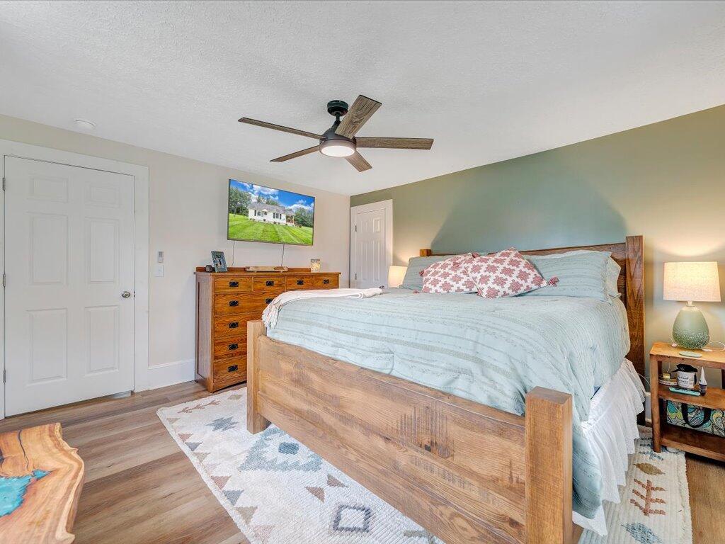 214 Spring Road Patrick Springs, VA 24133 - Photo 20 of 49 a bedroom with a bed and a chandelier