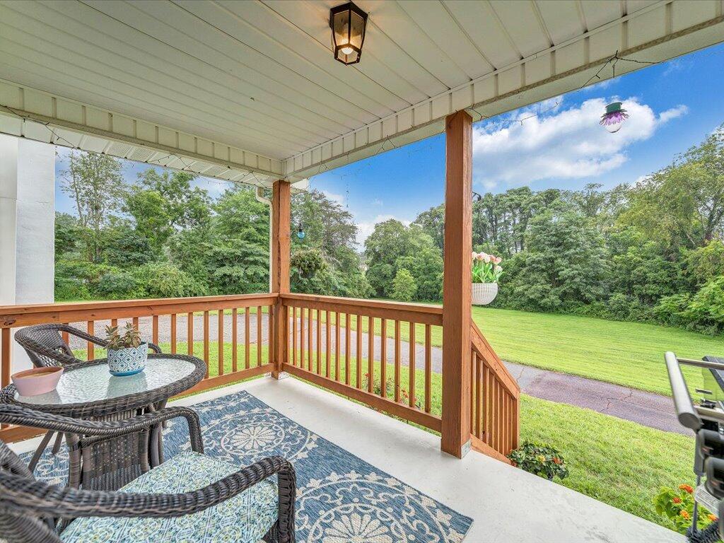 214 Spring Road Patrick Springs, VA 24133 - Photo 21 of 49 a view of a chair and tables in the patio
