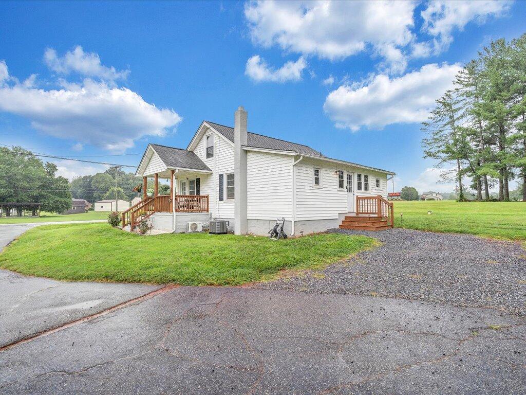 214 Spring Road Patrick Springs, VA 24133 - Photo 42 of 49 a view of a big house with a big yard and large trees