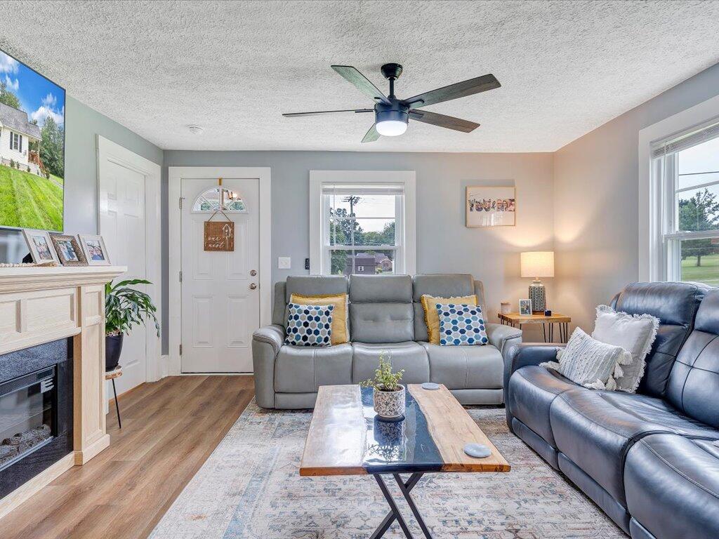 214 Spring Road Patrick Springs, VA 24133 - Photo 5 of 49 a living room with furniture and a fireplace