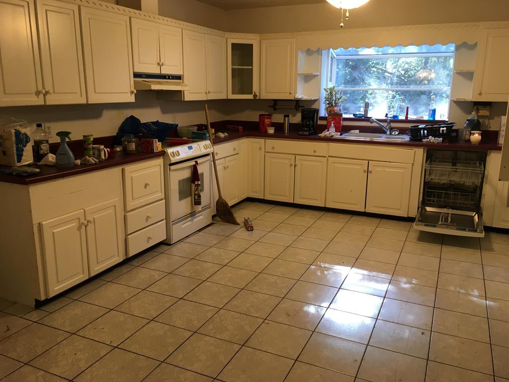 1064 Lee King Road Forsyth, GA 31029 - Photo 6 of 25 a kitchen with stainless steel appliances a sink cabinets and window