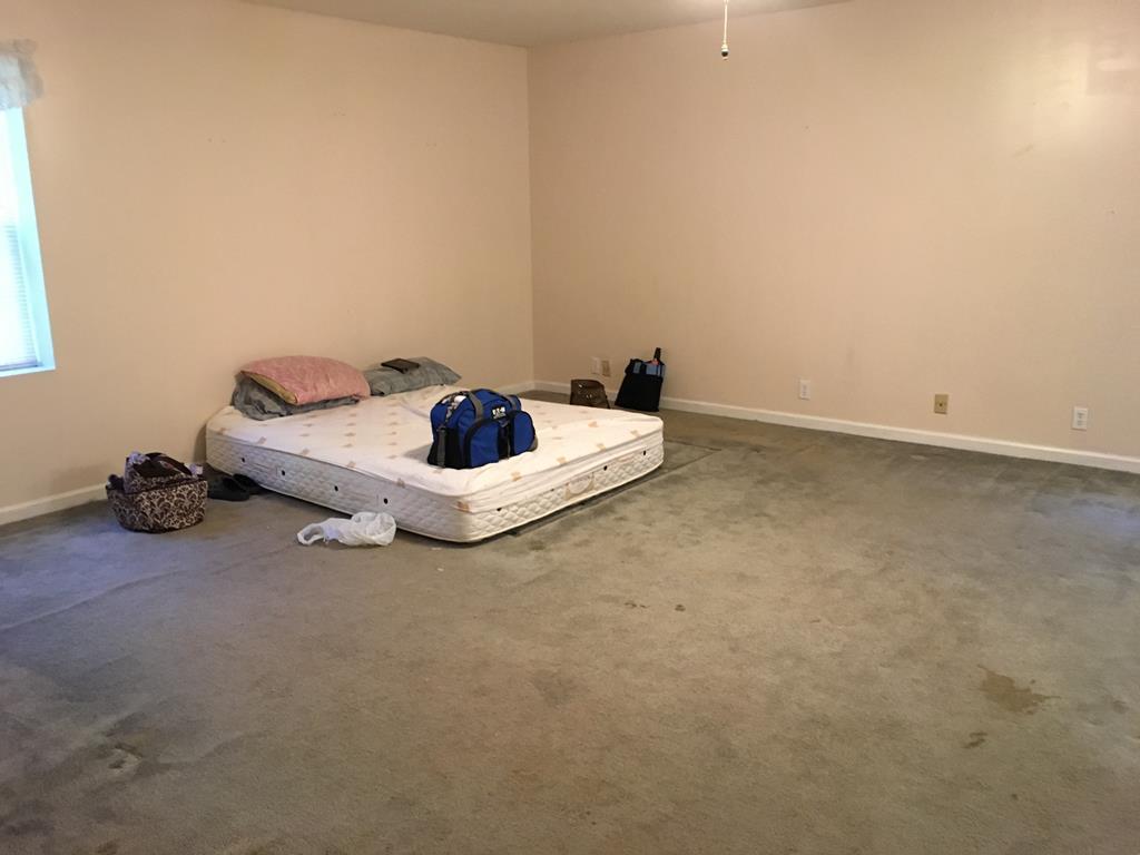 1064 Lee King Road Forsyth, GA 31029 - Photo 9 of 25 a living room with furniture and a wooden floor