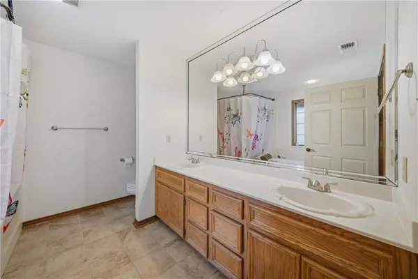 a bathroom with a sink double vanity and a mirror