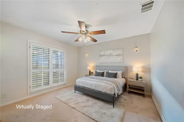 a bedroom with a bed and a large window