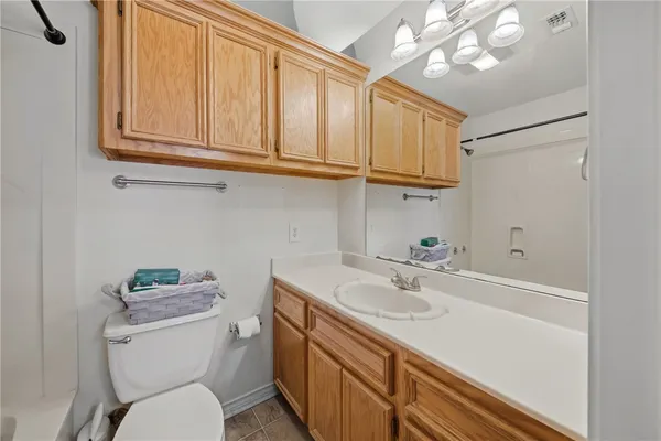a bathroom with a sink a toilet and a mirror