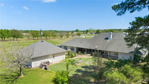 an aerial view of a house with big yard
