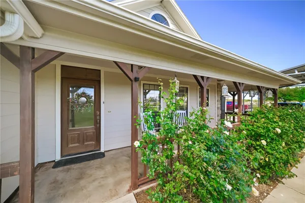 front view of a house with potted plants