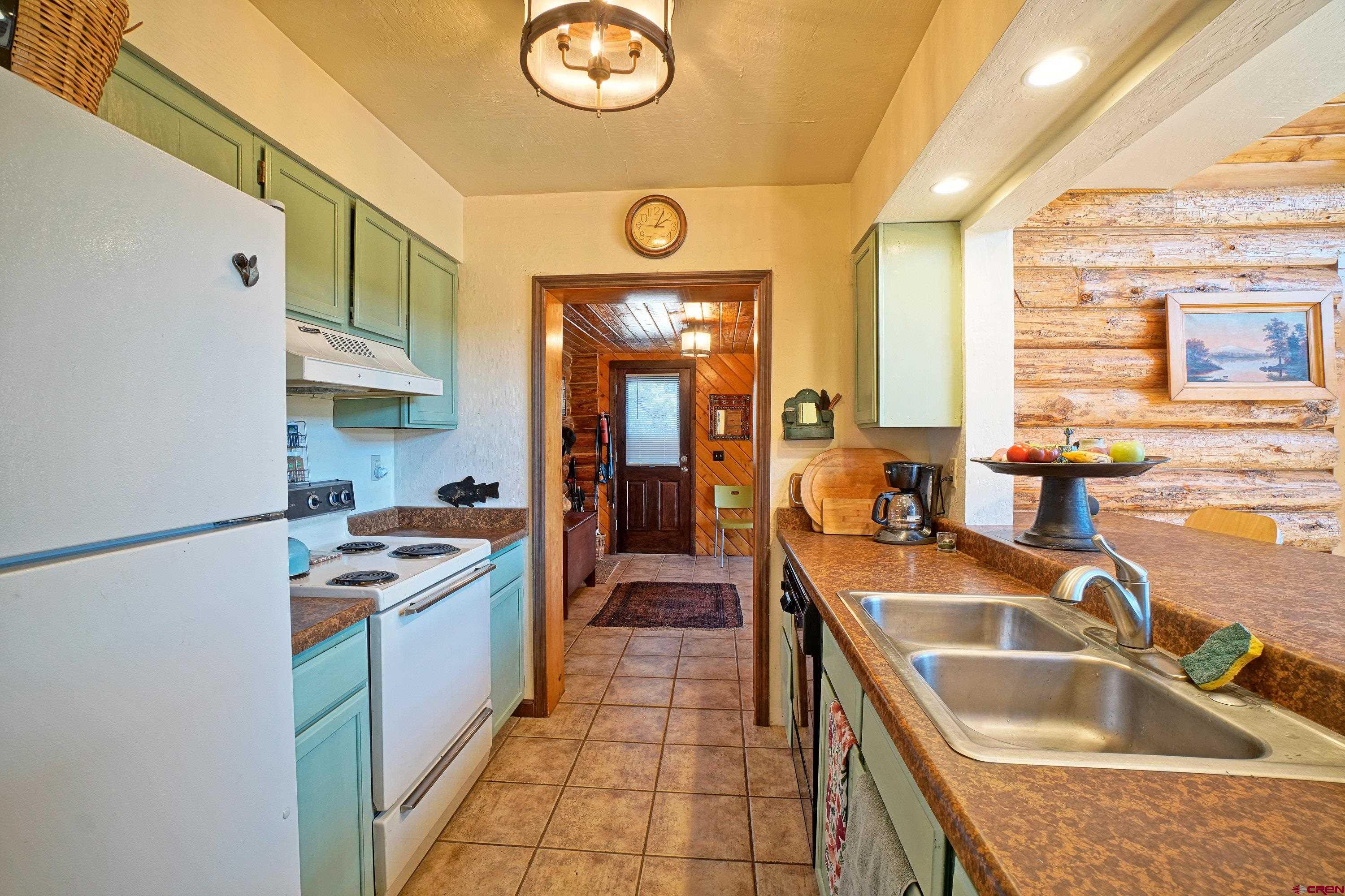 76 Tower Road South Ridgway, CO 81432 - Photo 6 of 37 a kitchen with granite countertop a sink and a stove top oven