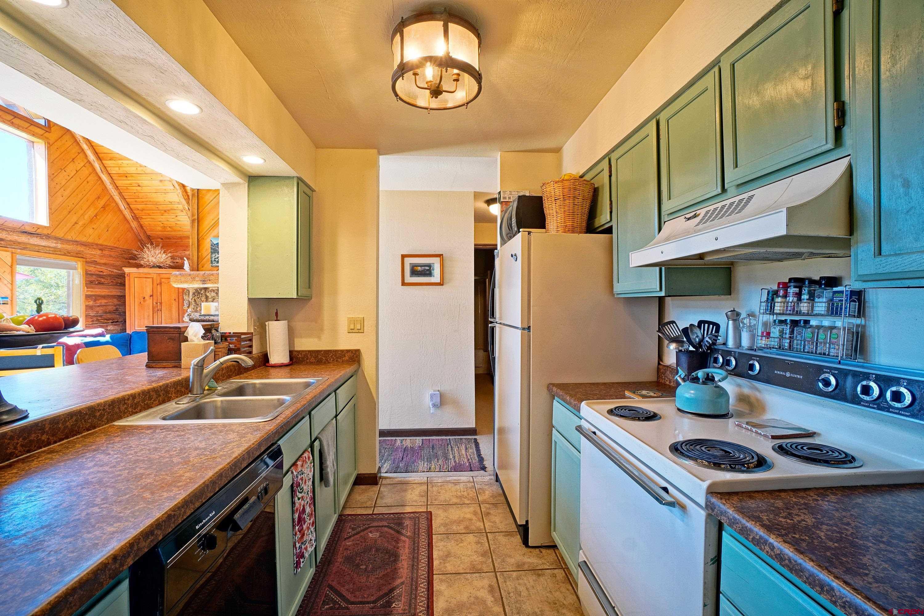 76 Tower Road South Ridgway, CO 81432 - Photo 7 of 37 a kitchen with stainless steel appliances granite countertop a sink stove and refrigerator