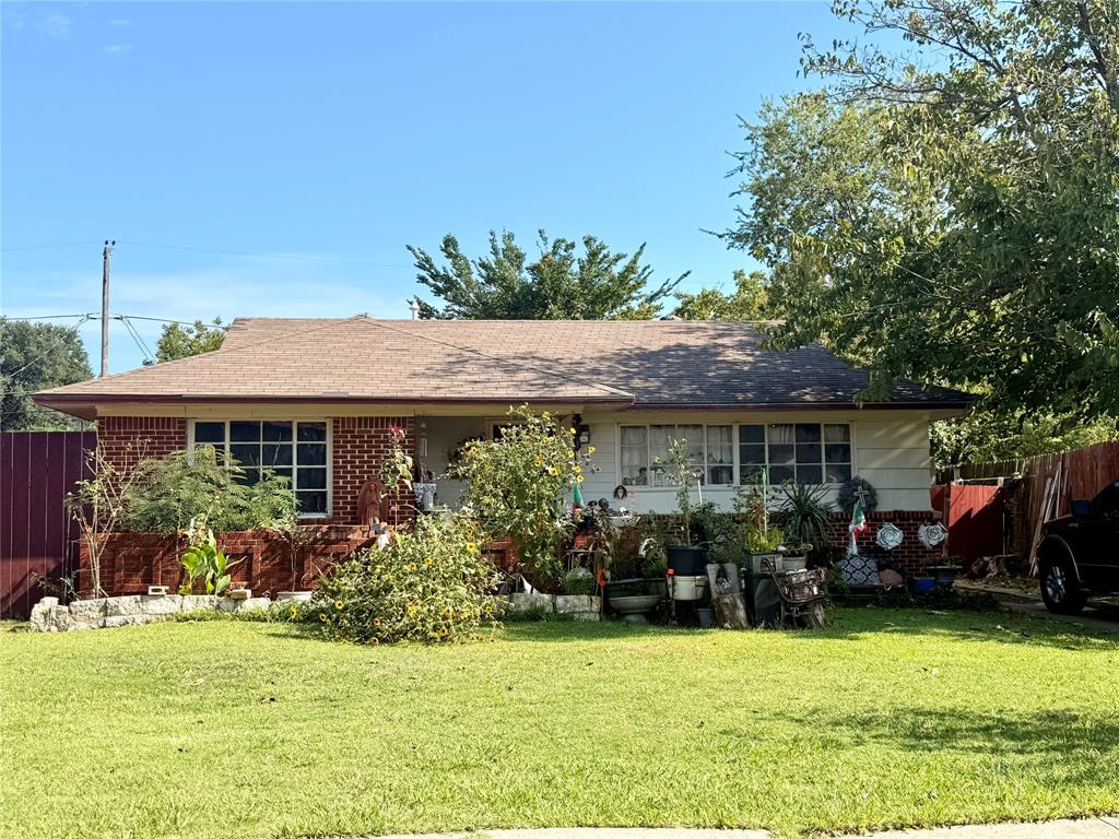 Single story home featuring roof with shingles and brick siding