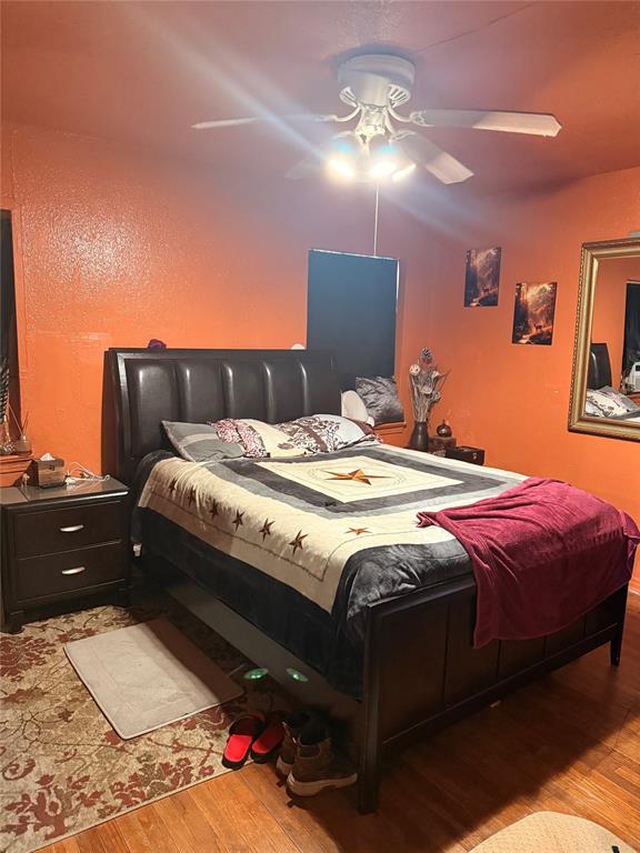 9918 Constance Street Dallas, TX 75220 - Photo 11 of 13 Bedroom featuring a textured wall, a ceiling fan, and wood finished floors