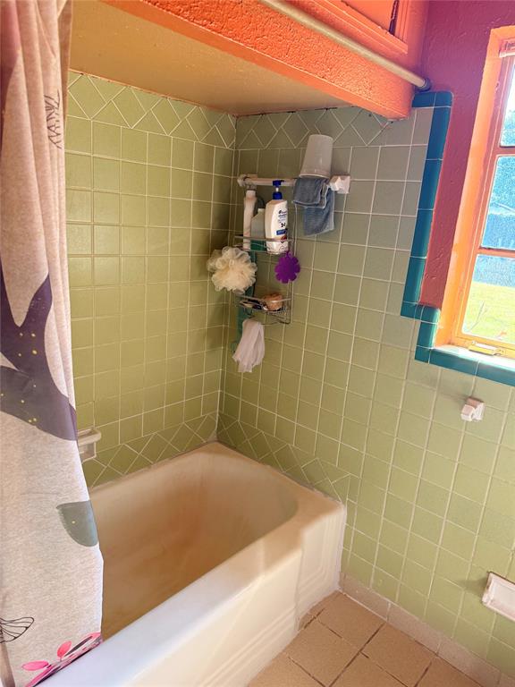 9918 Constance Street Dallas, TX 75220 - Photo 13 of 13 Full bathroom featuring tile patterned flooring and shower / bath combination with curtain