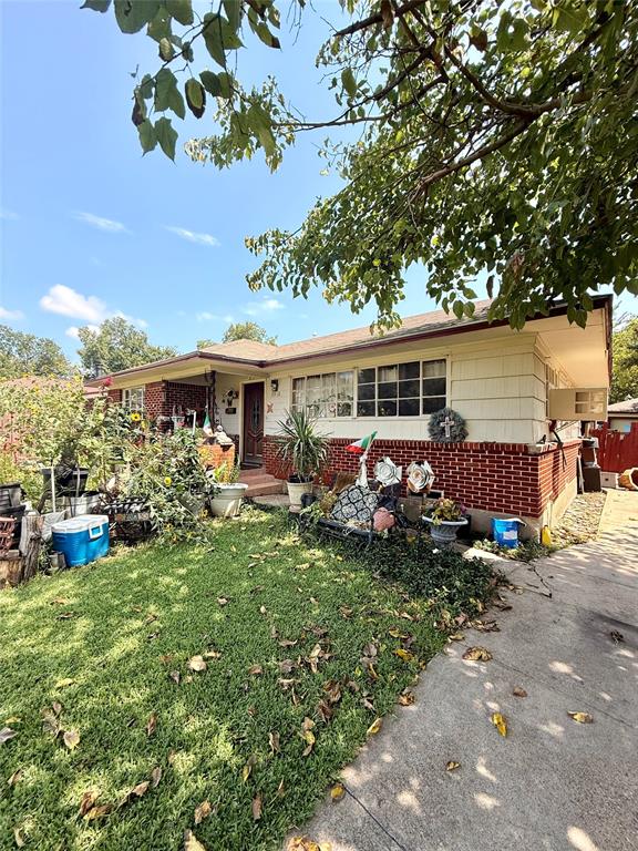 9918 Constance Street Dallas, TX 75220 - Photo 2 of 13 Ranch-style home featuring brick siding and a front yard