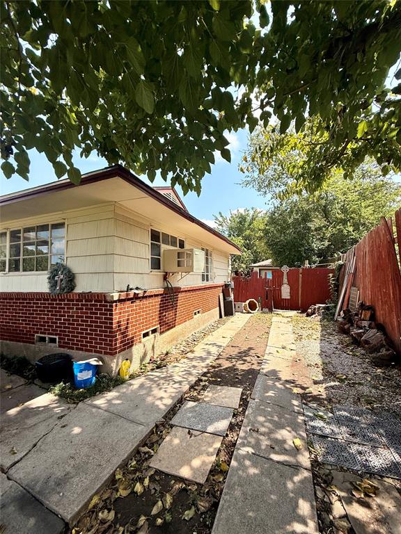 9918 Constance Street Dallas, TX 75220 - Photo 3 of 13 View of side of home with brick siding, a fenced backyard, and crawl space