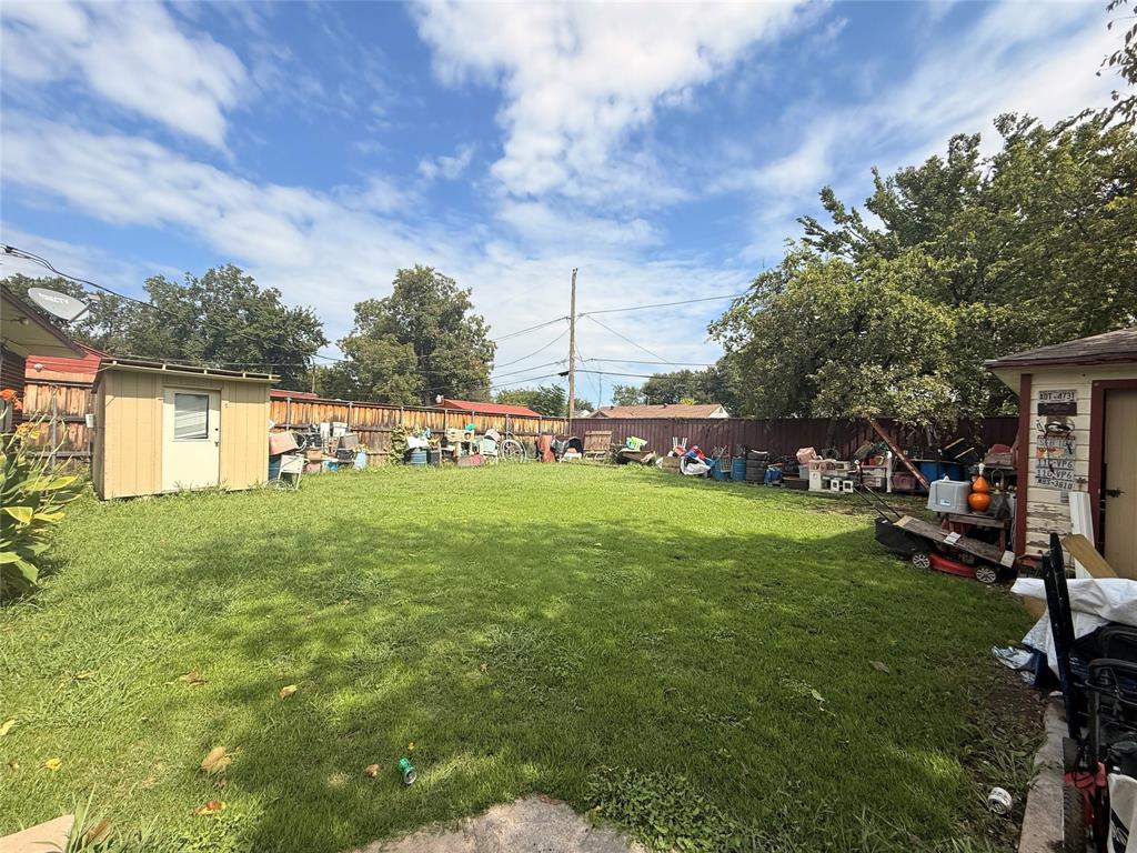 9918 Constance Street Dallas, TX 75220 - Photo 6 of 13 Fenced backyard with a storage unit