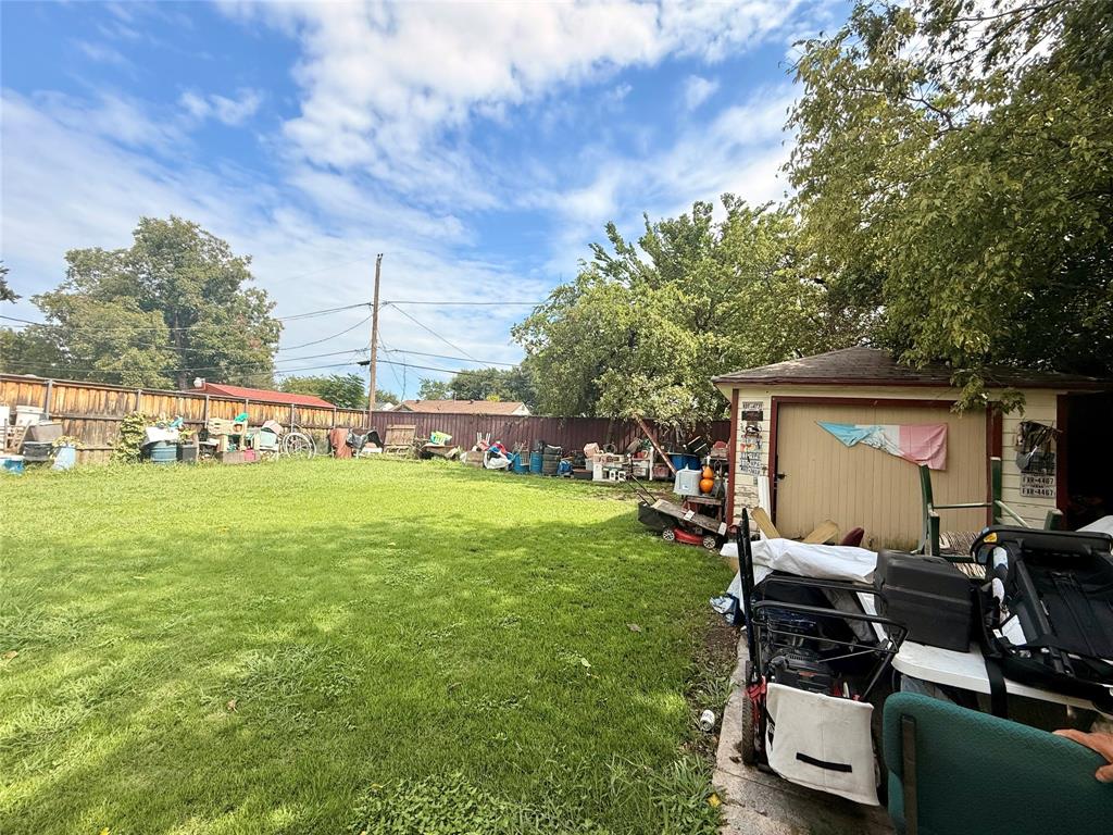 9918 Constance Street Dallas, TX 75220 - Photo 7 of 13 Fenced backyard featuring an outbuilding