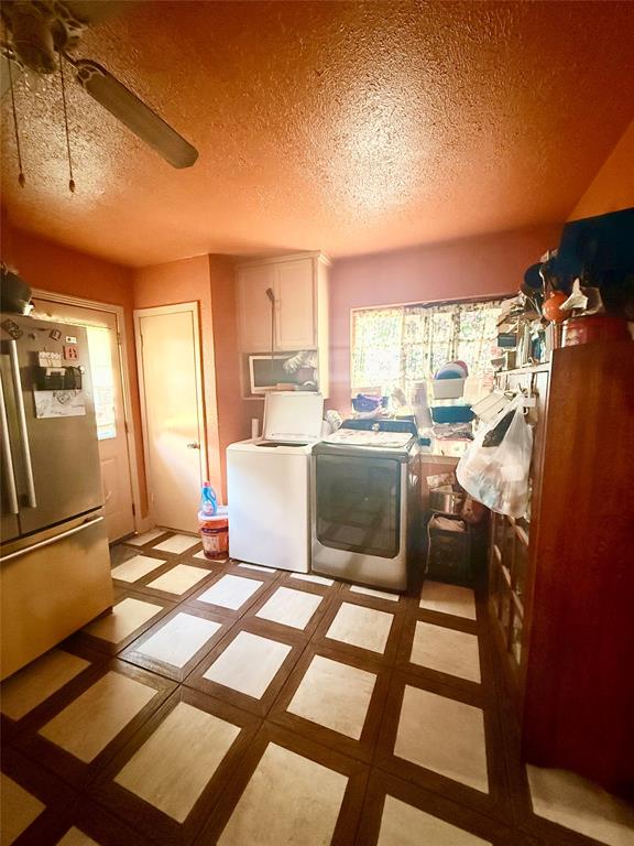 9918 Constance Street Dallas, TX 75220 - Photo 10 of 13 Laundry area featuring a textured ceiling, ceiling fan, and separate washer and dryer