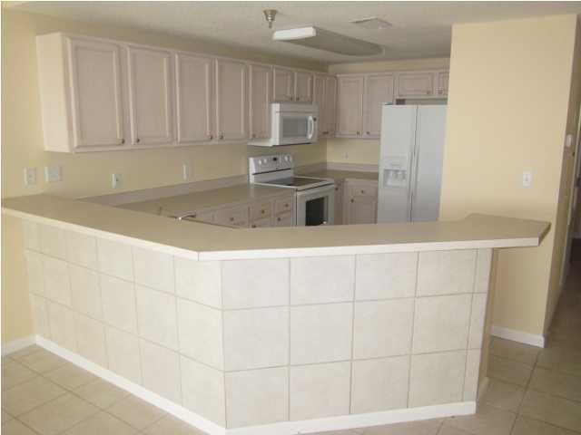 8600 East County Highway 30A, Unit 140 Seacrest, FL 32461 - Photo 6 of 16 a kitchen with a sink cabinets and stainless steel appliances