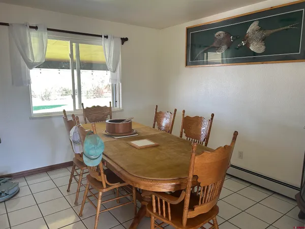 a view of a dining room with furniture and window