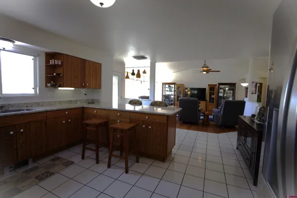 a kitchen with a sink cabinets and wooden floor