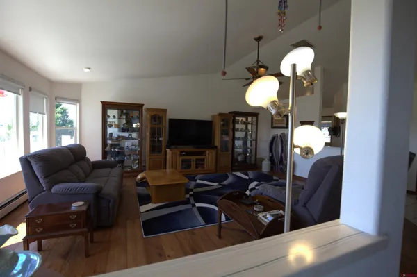 a living room with furniture chandelier and a mirror