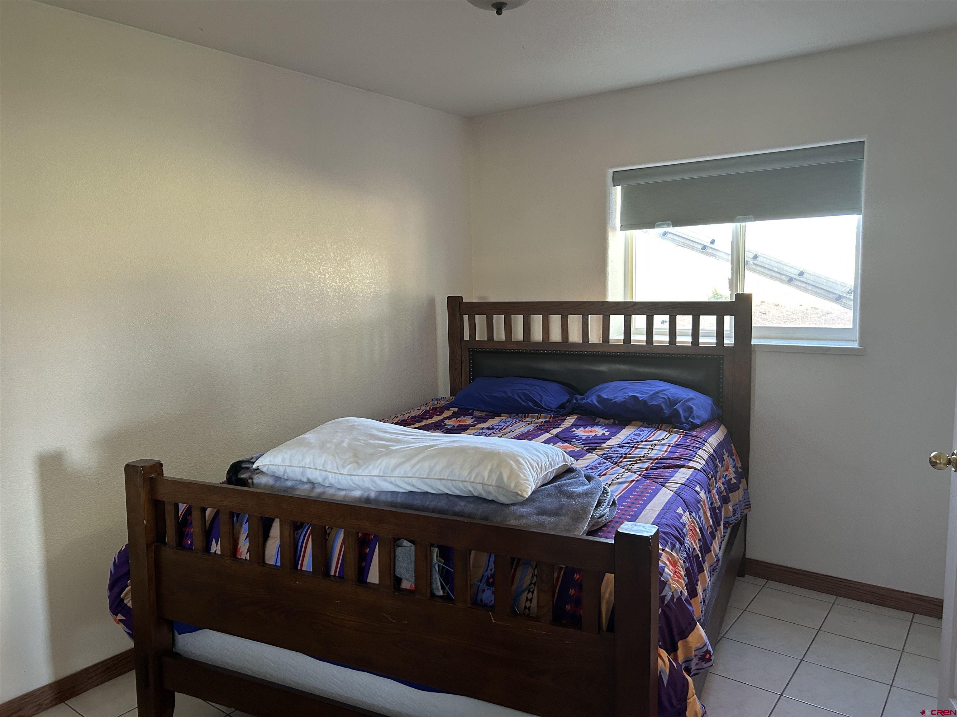 29669 DD Road Nucla, CO 81424 - Photo 24 of 33 a bed sitting in a bedroom next to a window