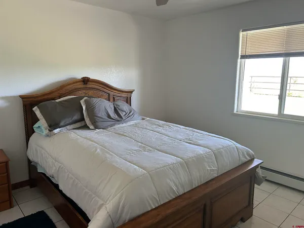 a bedroom with a bed and window
