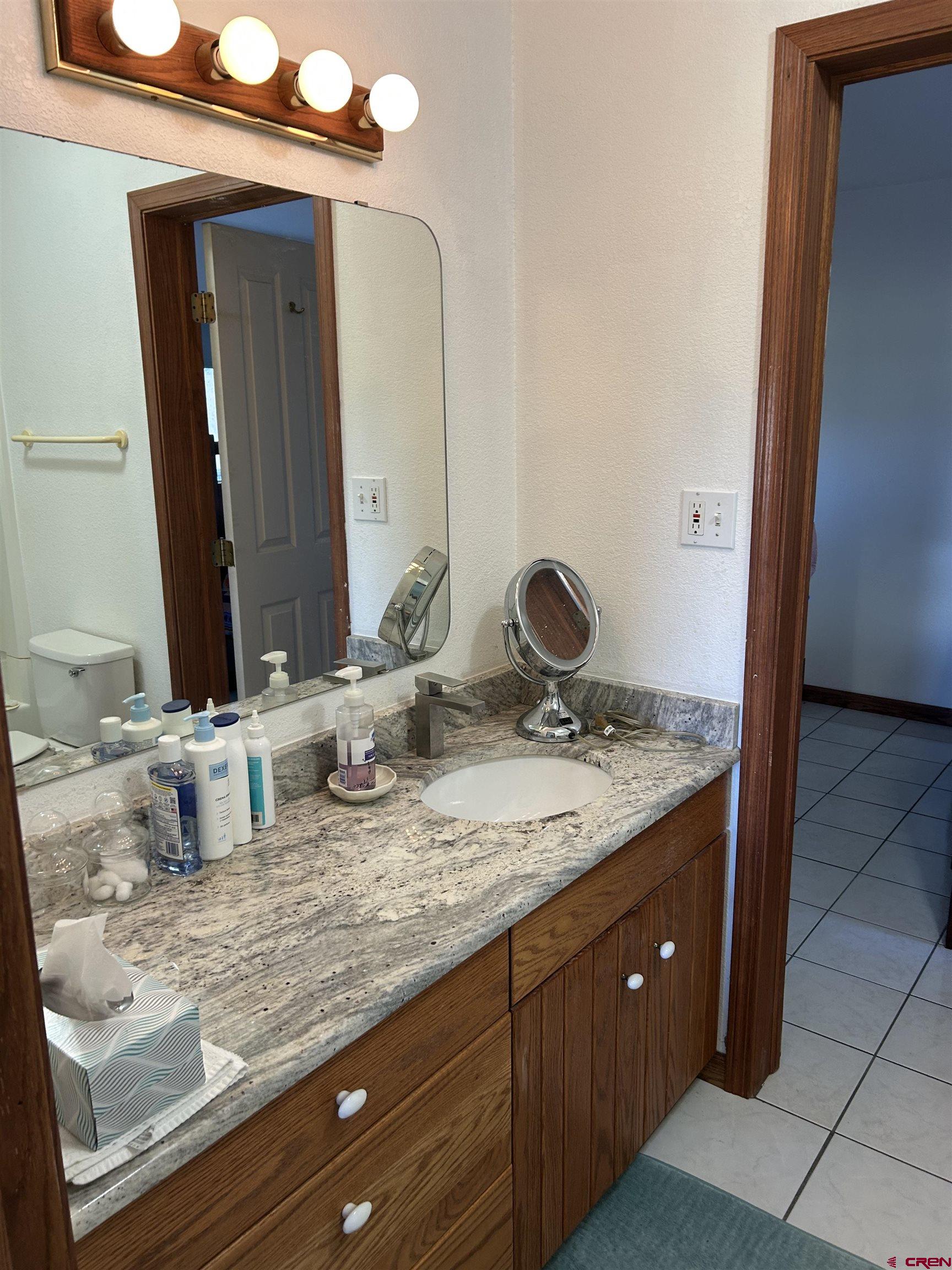 29669 DD Road Nucla, CO 81424 - Photo 27 of 33 a bathroom with a granite countertop sink and a mirror