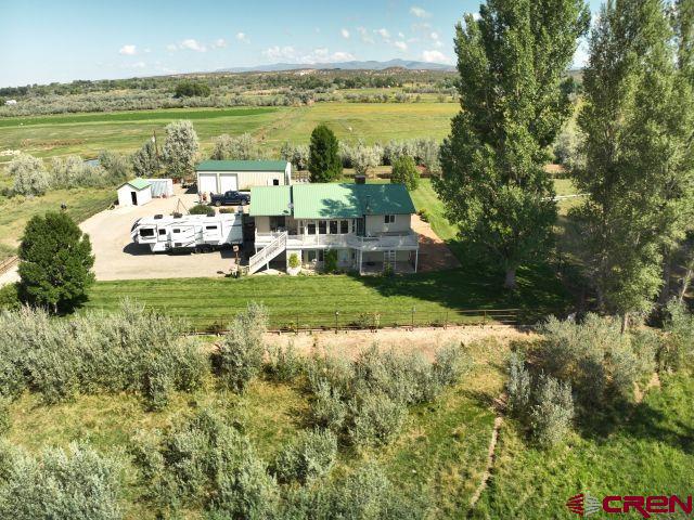 29669 DD Road Nucla, CO 81424 - Photo 6 of 33 a view of a lake with lawn chairs and large trees