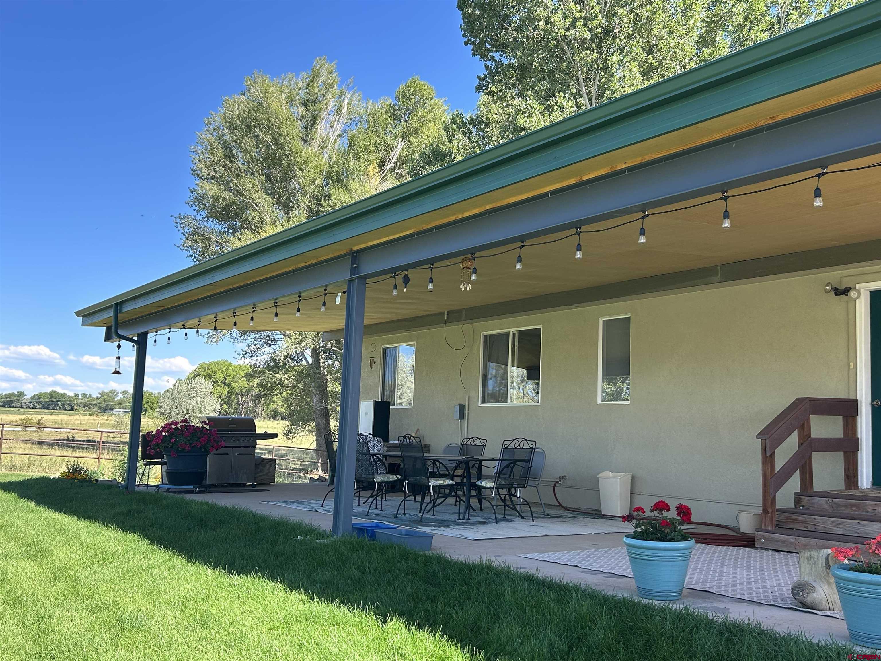 29669 DD Road Nucla, CO 81424 - Photo 8 of 33 a patio with table and chairs and potted plants with sky view