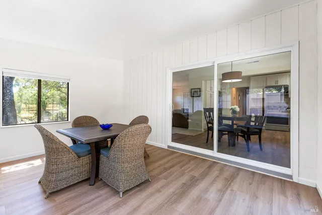a dining room with furniture and wooden floor