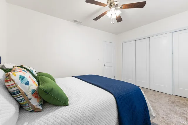 a bedroom with a bed and a chandelier